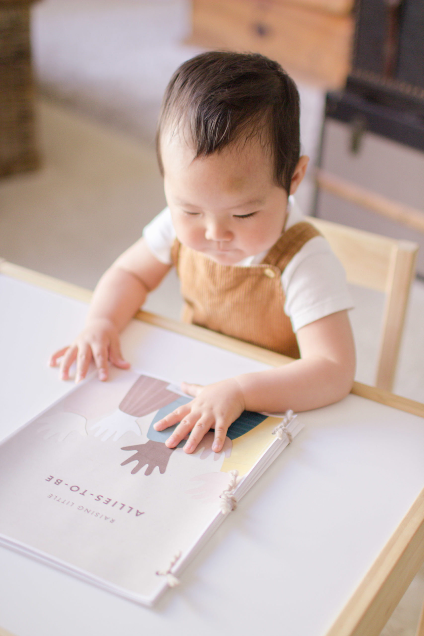 Little Baby places hands on Book about diversity. Tiffany Chi Photography